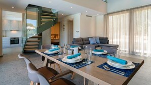 A modern living room with a dining area set for a meal. - Heated Private Pool★Brand New Lux villa★Walk to ALL★BBQ (Chania)