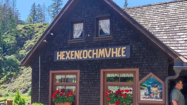 A traditional wooden building with a sign reading "HEXENLOCHMVHL". - Holiday apartment  (Todtnau)