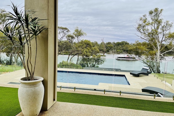 Heated swimming pool with Murray River views & glass panel fencing off alfresco