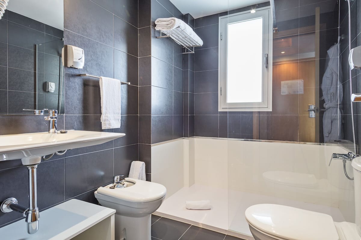 standard room | bathroom | hair dryer, towels, soap, shampoo