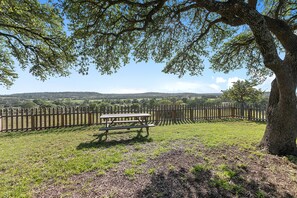 Enjoy a peaceful meal or relaxation in this secluded outdoor space with a picnic table surrounded by nature.