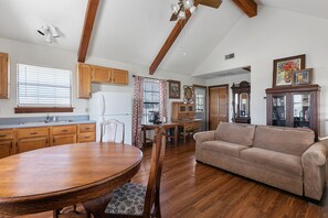 Relax in this well-appointed living area with a large dining table and comfortable seating.
