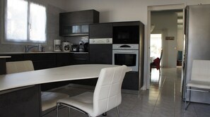 Enjoy cooking in this well-lit kitchen with a central island and essential appliances.