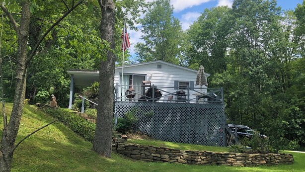 A house with a covered patio, stone retaining wall, and a flagpole. -  Reduced to $90.00 March-July week days (Byrnedale)