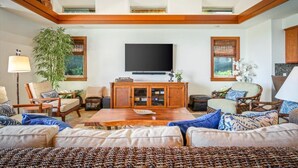 A spacious living room with a large flat-screen TV, wooden furniture, and a large plant. - Luxury 4 Bedroom with private pool & Spa (Waimea)