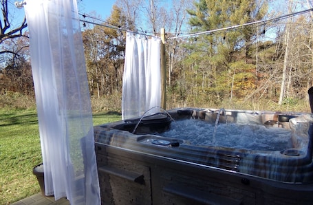 Outdoor spa tub. Golden Moose Cottage with hot tub