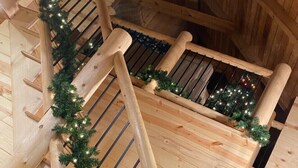 A wooden staircase with a garland of lights.