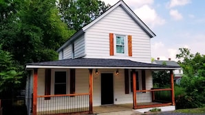A two-story house with a porch, a number '317' on the door, and a small attached garage. - Rivers Edge: Spacious, Riverwalk, Close to USC, Ft Jackson, all area Hospitals (West Columbia)