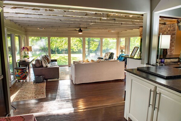 A spacious living room with a large window, a sofa, and a coffee table.