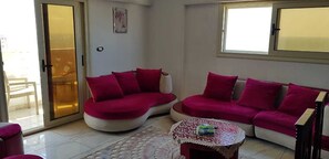 Luxury Apartment | Living area | 49-inch Smart TV with satellite channels, TV - luxury apartment CBD beach view Hilton (Alexandria)