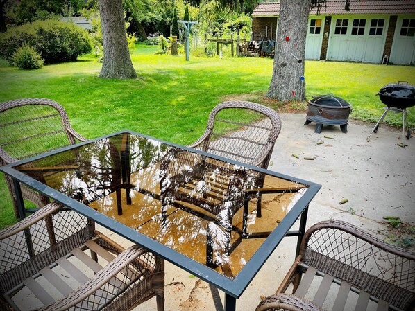 Relax on the patio surrounded by a well-manicured lawn and enjoy the barbecue grill.