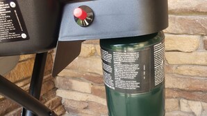A portable grill with a gas bottle attached. - COMFY  2 bedroom 1 bath, living room, mini kitchen with 70" smart TV & Grill (Montrose)