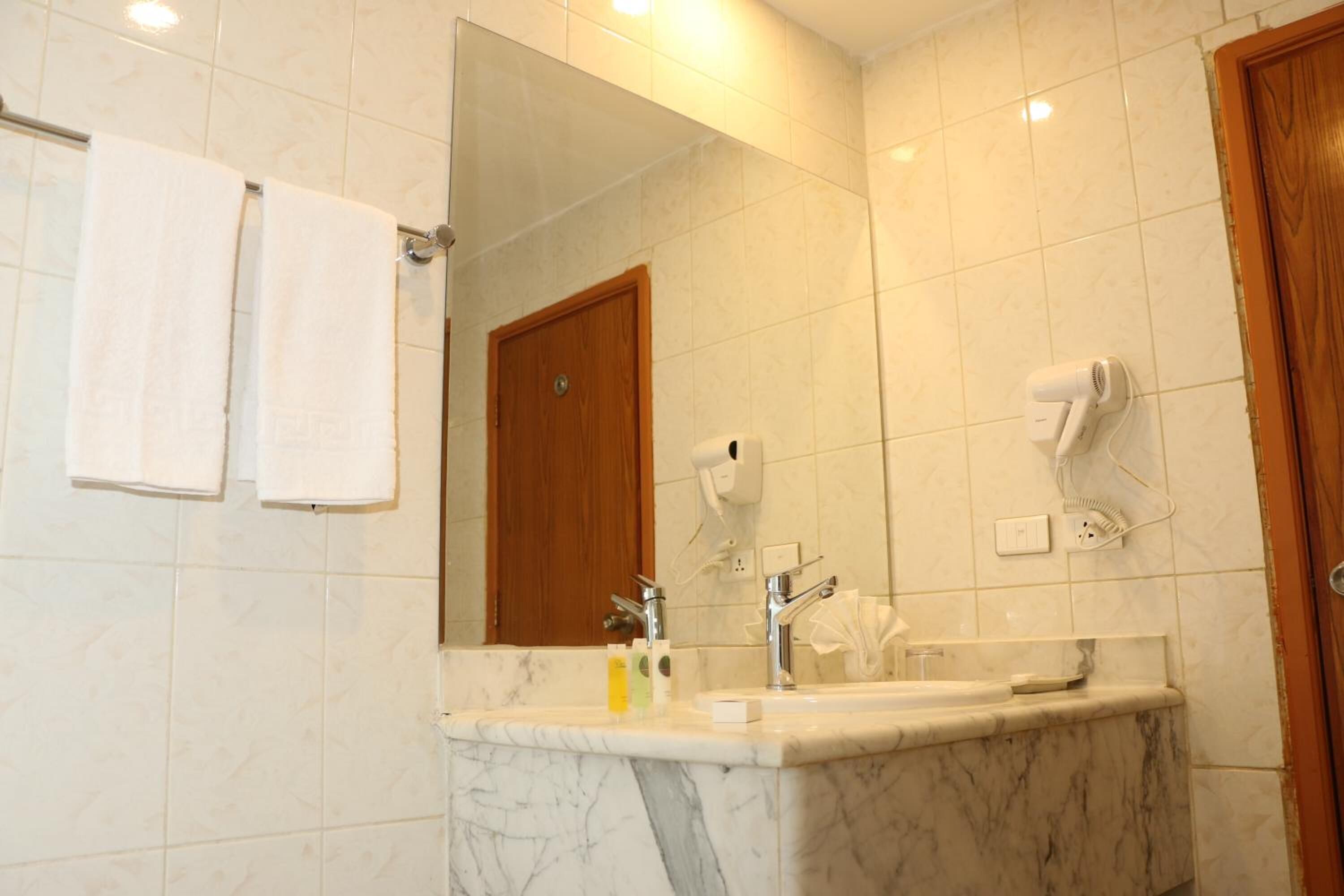 bathtub, hair dryer, bidet, towels