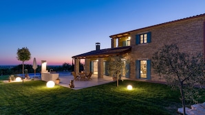 A spacious outdoor patio area with a pool, seating, and a covered section. - Villa Toscana by Interhome (Umag)