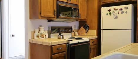 Fridge, stovetop, dishwasher, coffee/tea maker