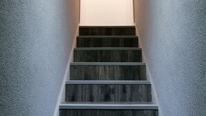 A staircase with wooden steps and a framed picture at the top. - Charming 1-bed Apartment in Coventry (Coventry)