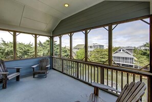 Relax on the covered deck with Adirondack chairs and take in the view of the surrounding neighborhood.
