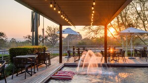 A rooftop bar with outdoor seating, a hot tub, and a sunset view. - The Capital Mbombela (Mbombela)