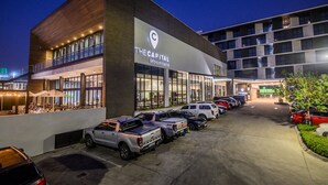 A hotel with a modern design, featuring a prominent sign with a location pin symbol and the name "The Capital Mombelena". - The Capital Mbombela (Mbombela)