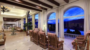 A spacious lobby with high ceilings, large arched windows, and a variety of seating options including wicker chairs and sofas. - Miyako Resort Shima Bayside Terrace (Shima)