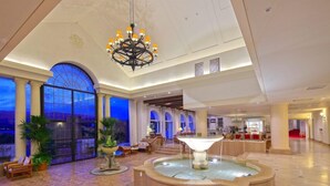 A spacious lobby with a fountain, seating areas, and large windows offering views. - Miyako Resort Shima Bayside Terrace (Shima)