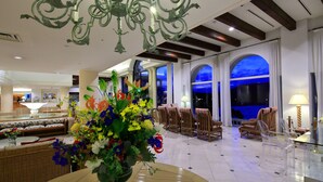 A spacious lobby with a chandelier, seating area, and large windows with a view of the sky. - Miyako Resort Shima Bayside Terrace (Shima)