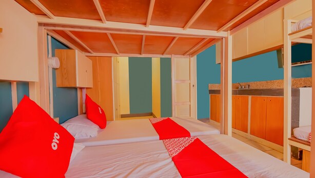 Een hotelkamer met een stapelbed, een bureau en een garderobe.
