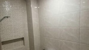 A bathroom with a toilet, sink, and shower. - Capital O 811 Tri A's Building (Olongapo)