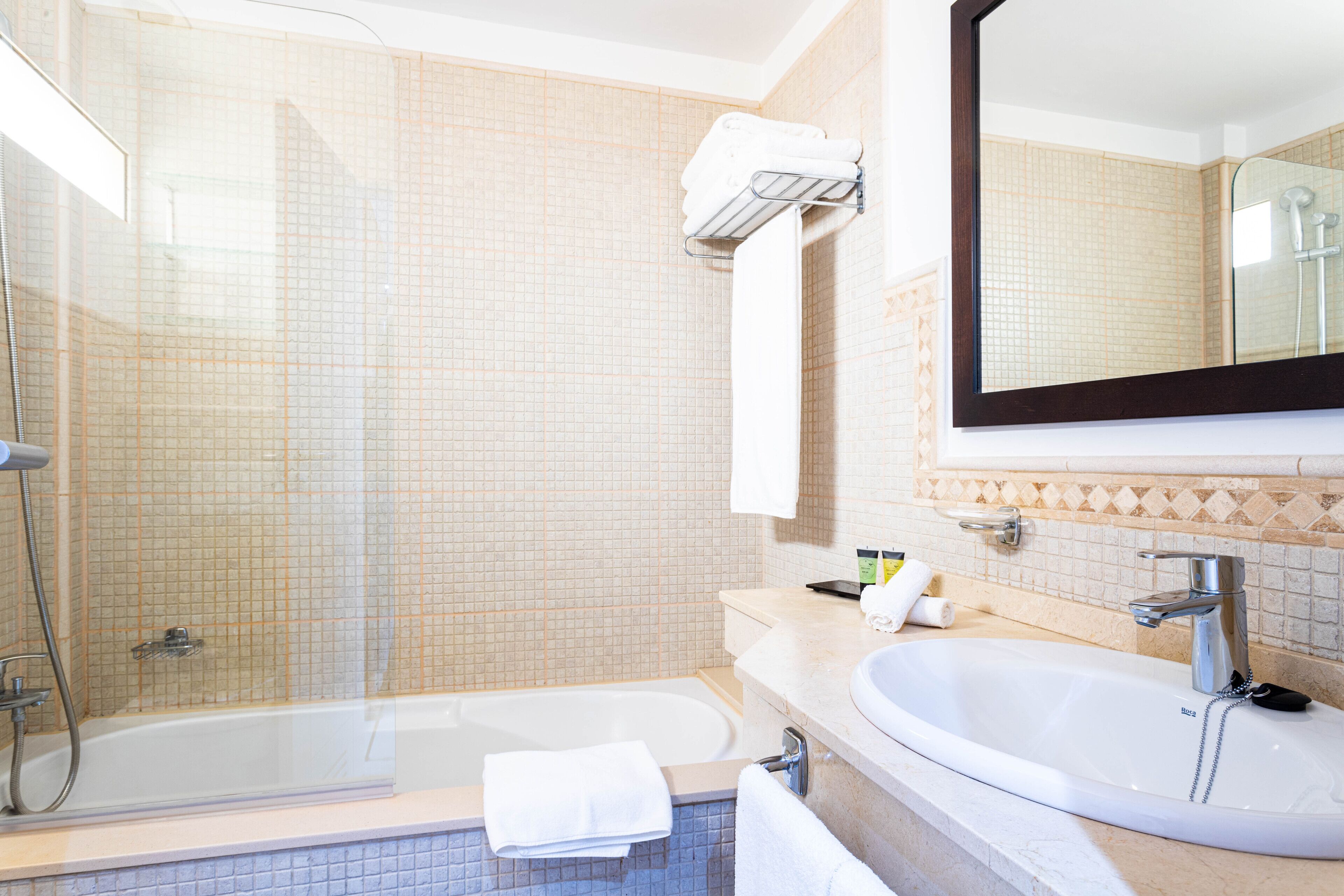 A bathroom with a bathtub, a sink, and a shower.