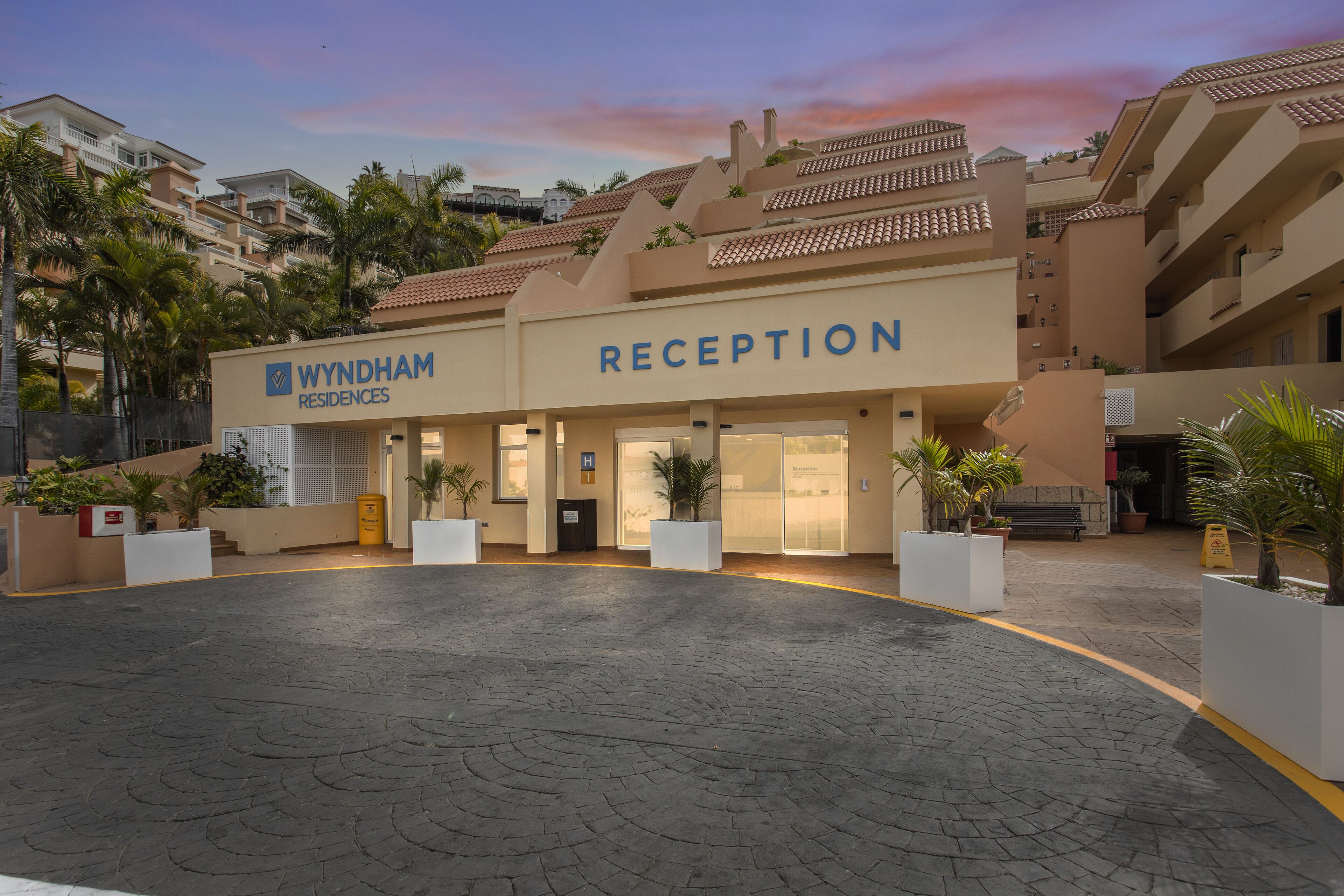 Wyndham Reception building with a paved entrance and potted plants.