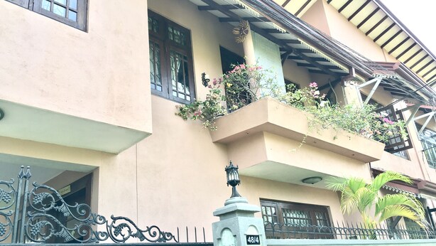 Un immeuble à plusieurs étages doté de balcons, d’une entrée sécurisée et d’une plaque indiquant le numéro de la rue.