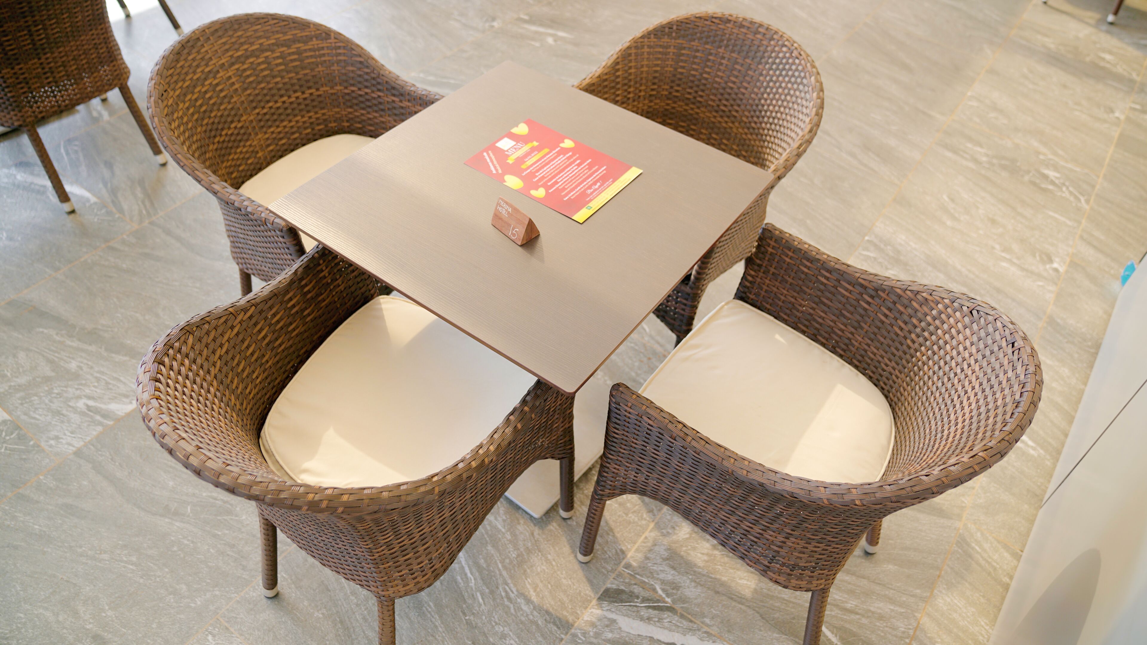 A table with a menu and a wooden block with the number 15.