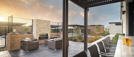An outdoor patio area with seating and a bar.