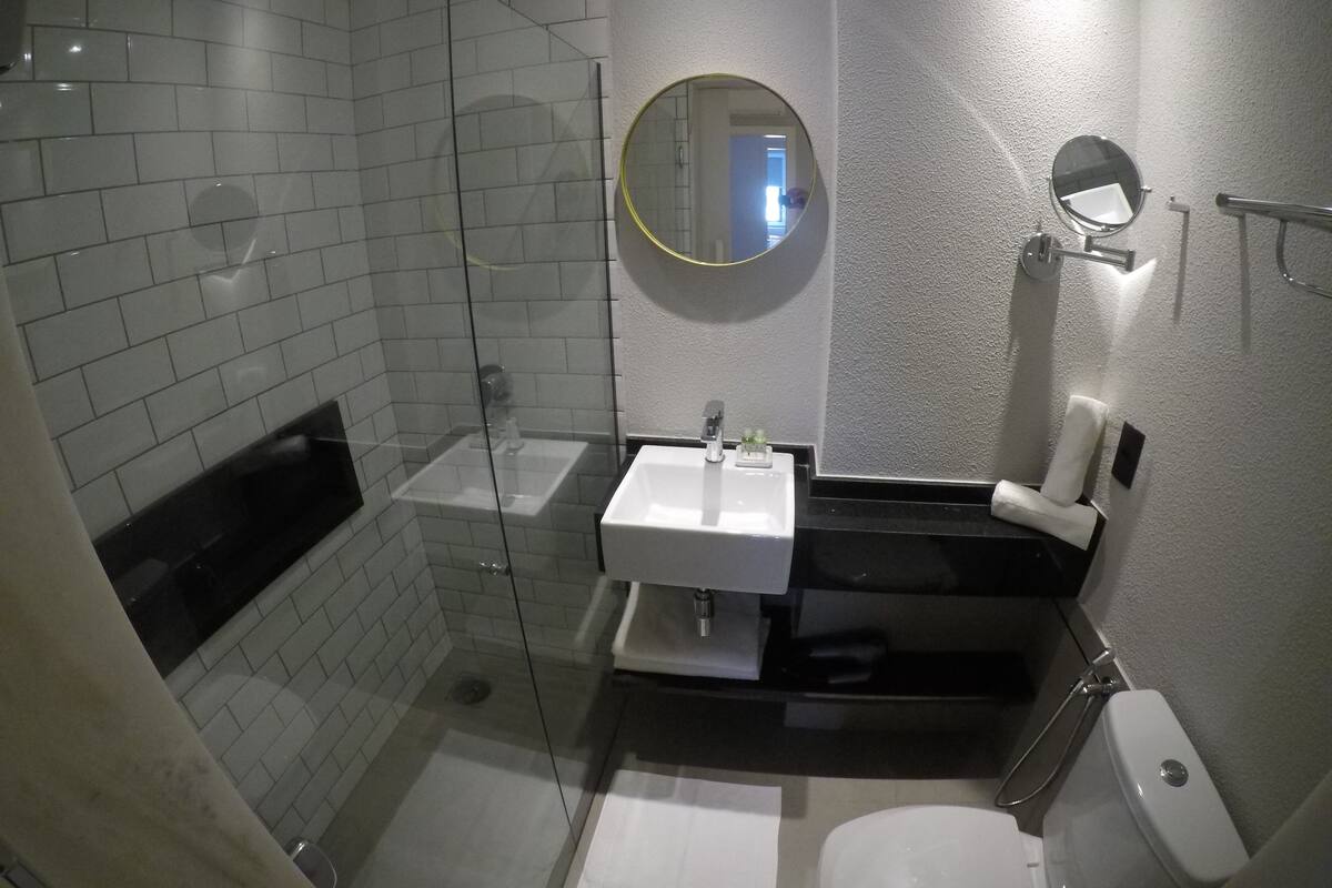 standard twin room | bathroom | shower, rainfall showerhead, eco-friendly toiletries, hair dryer