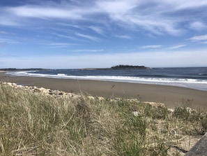 A beach with waves, grassy dunes, and a distant island. - Luxury RV get away near Kport (Arundel)