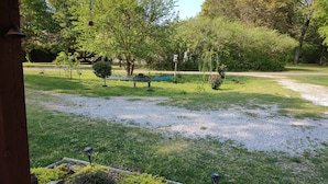 A garden with a pathway, benches, and a small pond. - Cozy 1 Room Cabin (Mountain View)