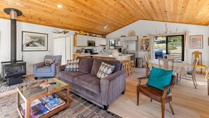 A cozy living area with a sofa, coffee table, and a fireplace.