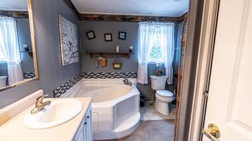 Combined shower/bathtub, towels, soap, toilet paper