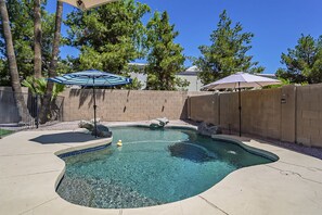 A swimming pool with a curved edge, surrounded by a brick wall and a concrete deck. - Moore House ~ Downtown Gilbert w/ Pool & Yard Games (Gilbert)