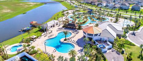 A resort with a large central pool, a smaller pool, and a water park area.