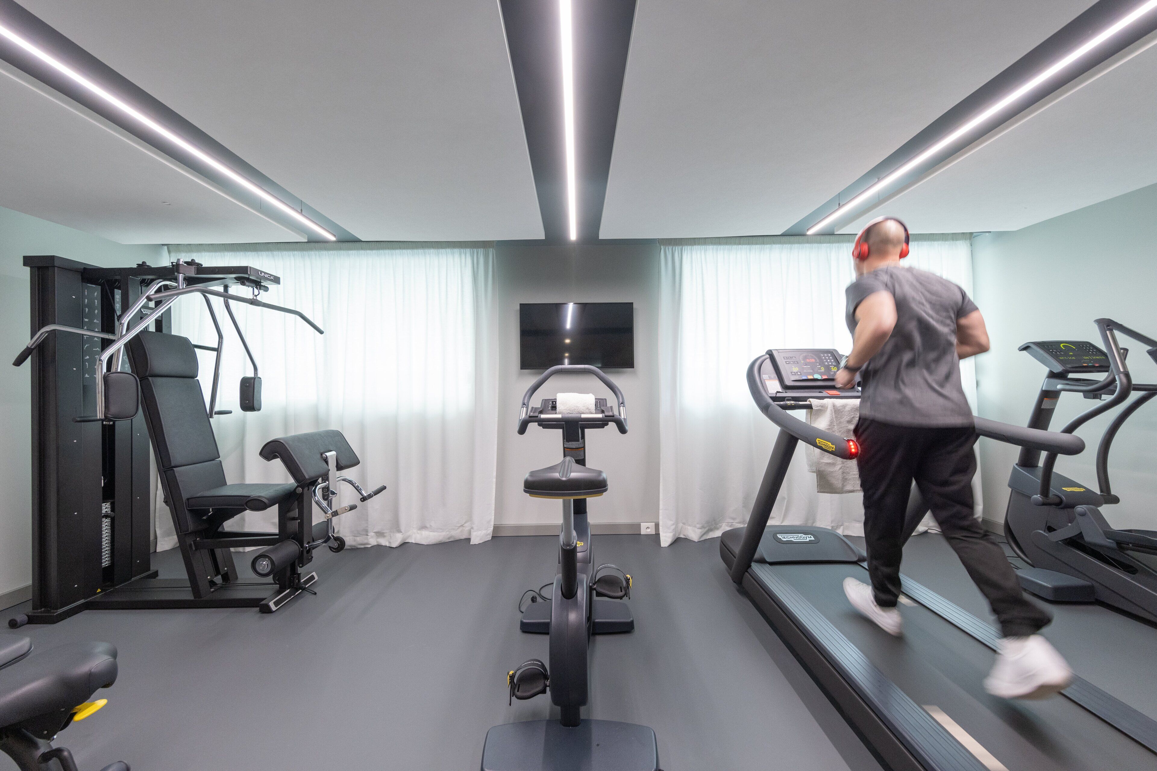 A gym with treadmills, a stationary bike, and weight machines.