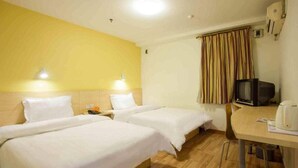A hotel room with two beds, a small table with a kettle, a television, and a window with curtains. - 7 Days Inn Shenzhen Longhua Branch (Shenzhen)