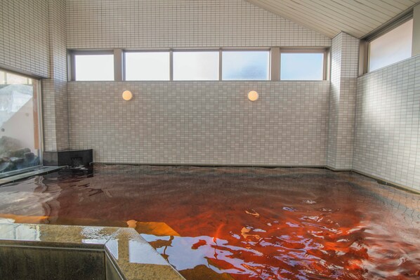 A large indoor swimming pool with tiled walls and a glass barrier. - FLEXSTAY INN Kashima Central (Kamisu)