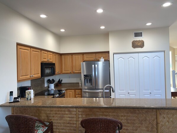 Enjoy cooking in this well-equipped kitchen with a central island, microwave, and ample cabinetry.