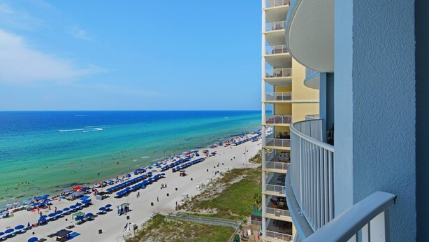 A high-rise hotel overlooking a beach with multiple balconies and a pool. - Twin Palms 1103 (Panama City Beach)