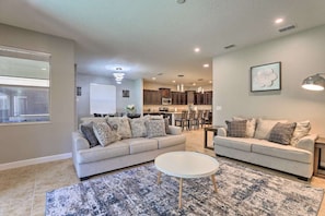 Relax in this stylish living room with two sofas, a coffee table, and a large area rug.