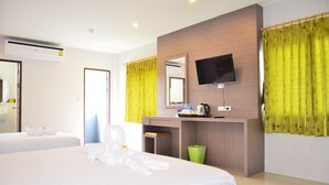 A hotel room with two beds, a flat-screen TV mounted on the wall, a small desk with a kettle, and a green trash bin. - Fahsai Hotel Aonang (Krabi)
