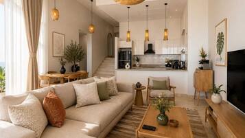 A modern living room with a sofa, coffee table, and a TV stand.