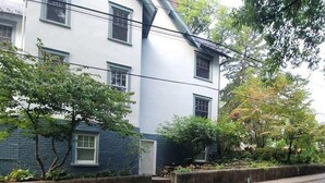 A two-story building with a white facade and dark blue trim.