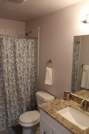 Combined shower/bathtub, towels, toilet paper